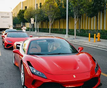 Red Ferrari from the Dynasty fleet driving through Miami