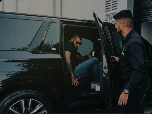 Dynasty valet assisting a client out of a black SUV